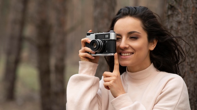 Smiley woman with camera