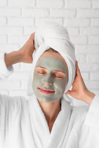 Smiley woman with facial treatment
