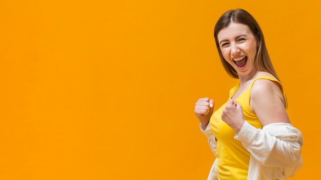 Smiley woman with fists ready to fight