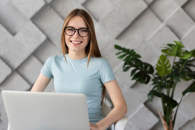 Smiley woman with glasses looking at the camera