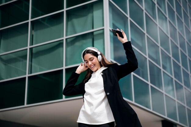 Smiley woman with headphones medium shot