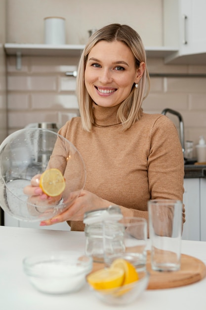 Free photo smiley woman with lemon slice medium shot