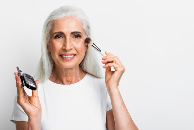 Smiley woman with makeup elements