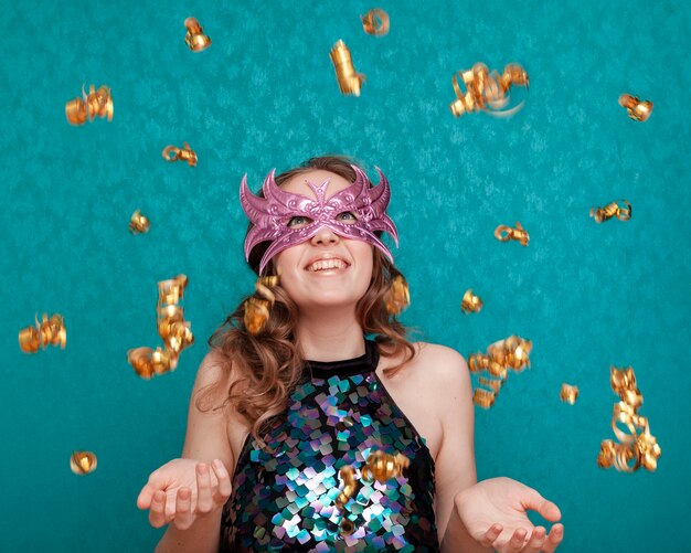 Smiley woman with mask and raining ribbons