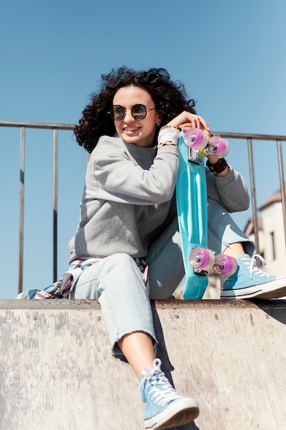 Smiley woman with penny board