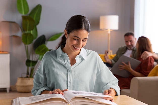 Smiley woman with picture album medium shot