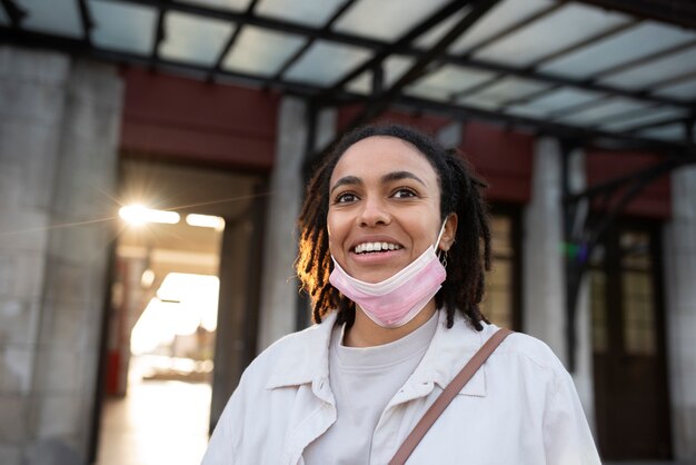 Smiley woman with pink mask low angle