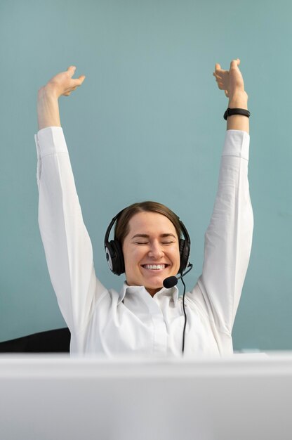 Smiley woman working in a call center office