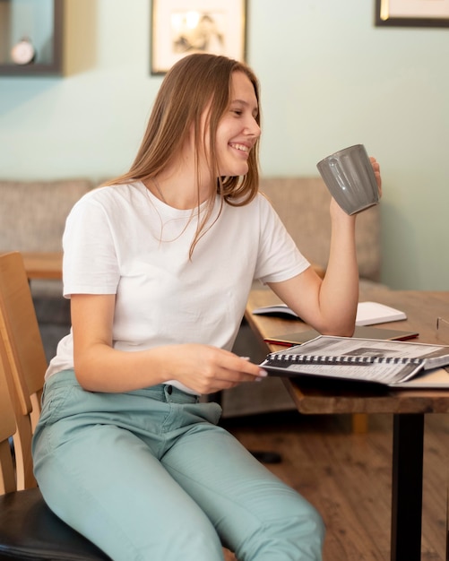 Free photo smiley woman working from home during the pandemic