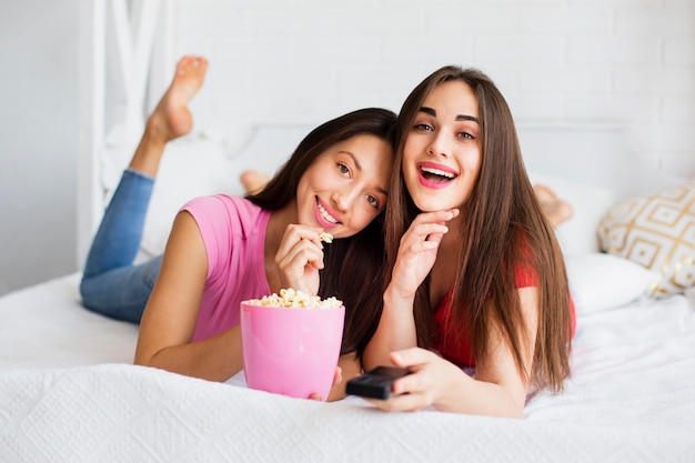 Smiley women in bed looking at camera