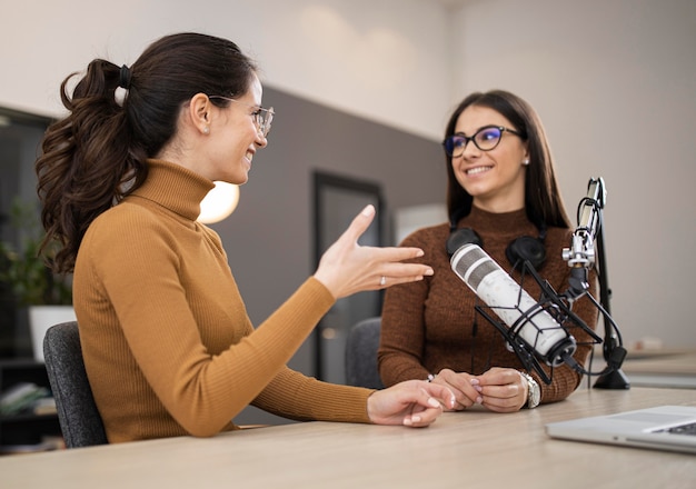 Free photo smiley women broadcasting on radio together