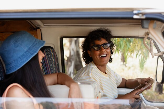 Smiley women in campervan medium shot