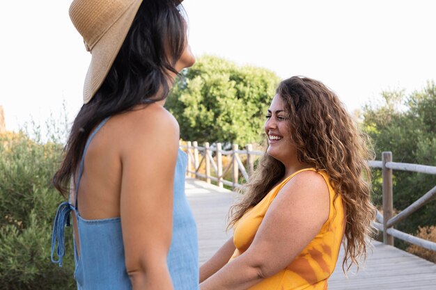 Smiley women friends outdoors laughing