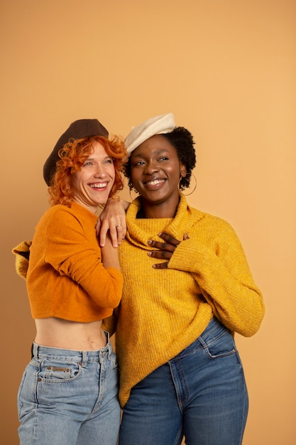 Smiley women posing together medium shot