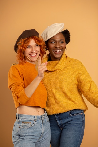 Smiley women posing together medium shot