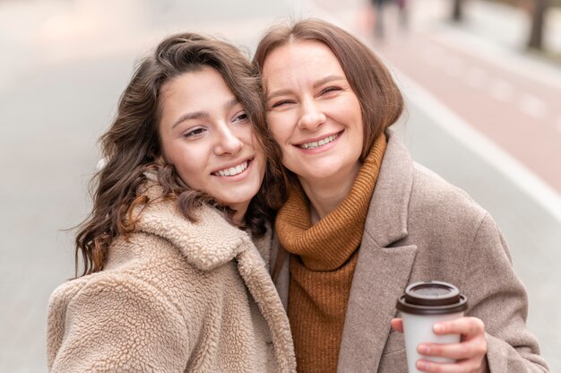 Smiley women posing together outdoors