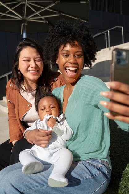 Smiley women taking selfie outdoors medium shot