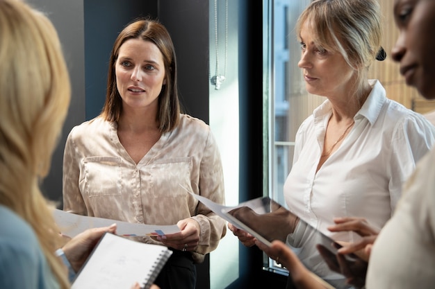 Smiley women working with tablet at office