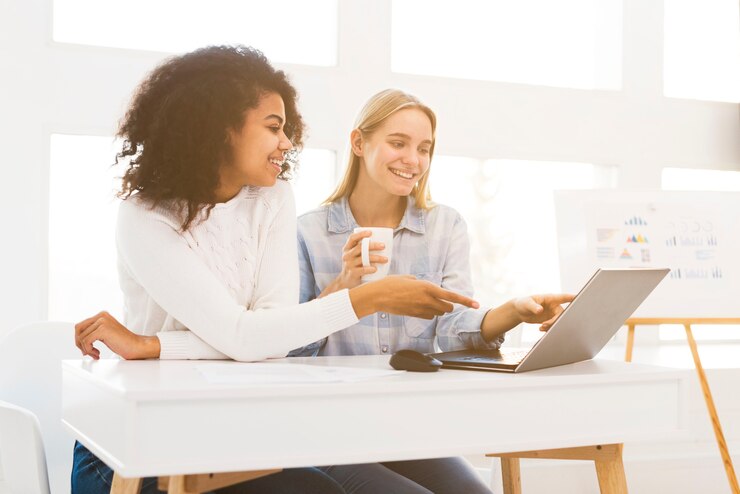 Free Photo smiley womens working on laptop