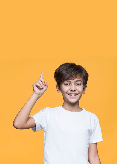 Smiley young boy pointing