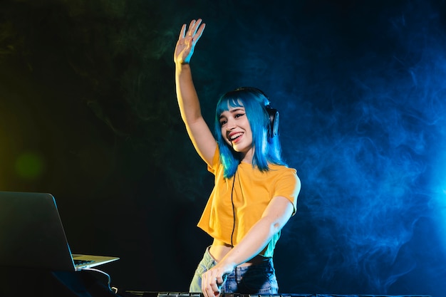 Free photo smiley young female dj mixing