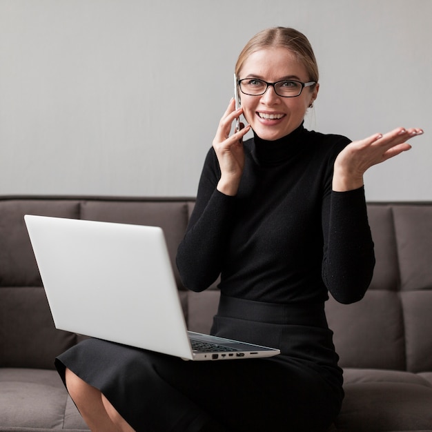 Smiley young female talking at mobile