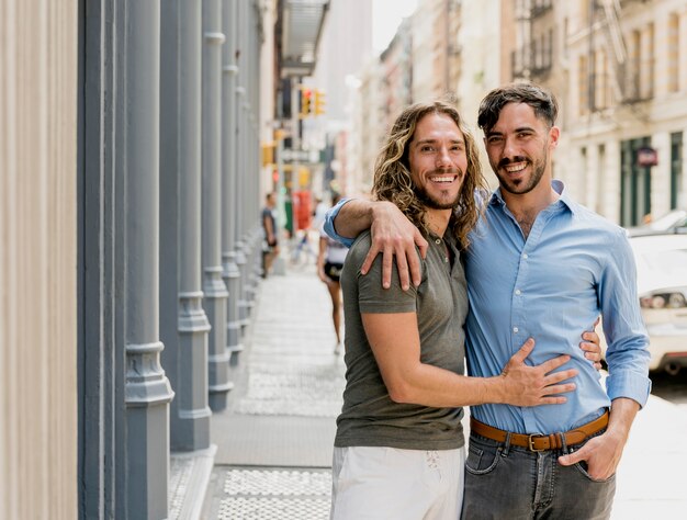 Smiley young friends outdoors hugging