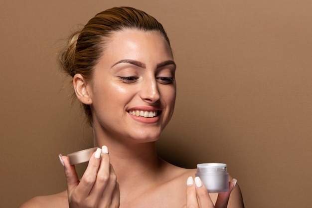 Smiley young girl testing skin care products