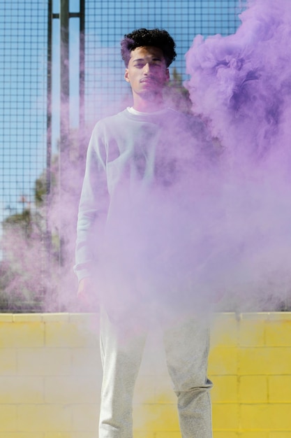 Free photo smiley young man outdoor in color explosion