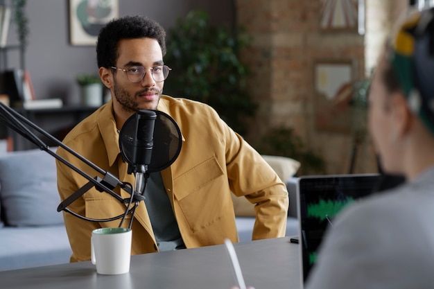 Free photo smiley young man at podcast