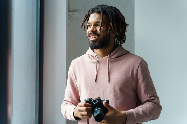 Free Photo smiley young man with camera