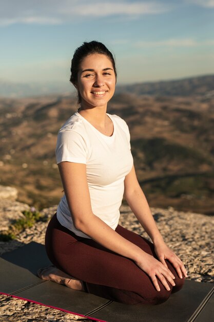 Smiley young woman meditating