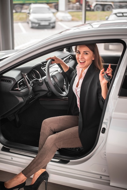 Smiley young woman testing a car