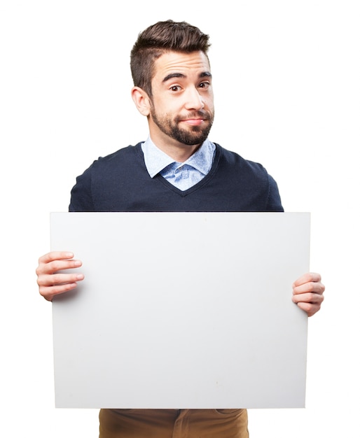 Smiling adult showing blank signboard