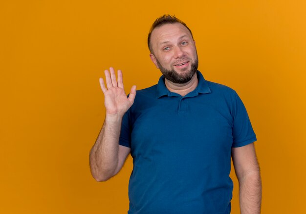 Smiling adult slavic man looking and waving 