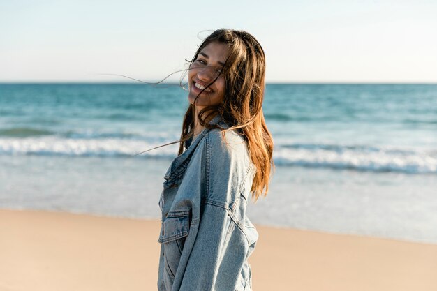 Smiling adult woman on beach looking at camera