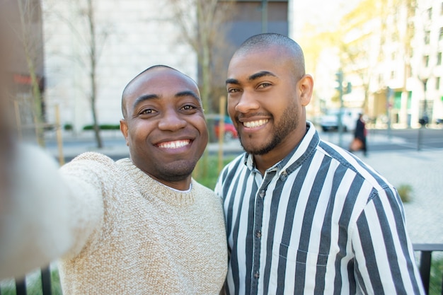 Smiling African American friends taking selfie