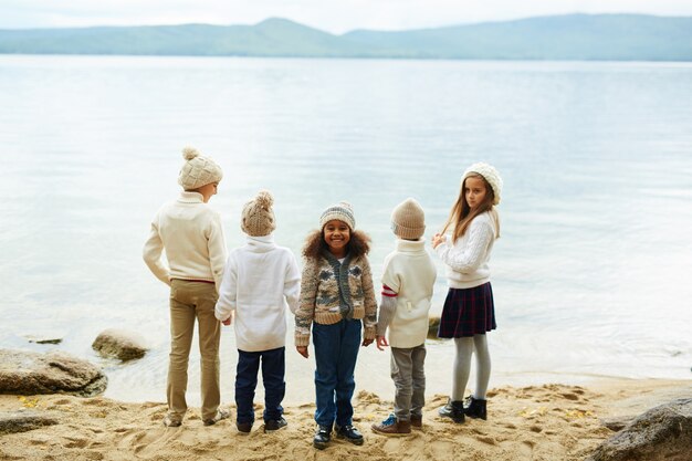 Smiling African Girl with Friends on Lake