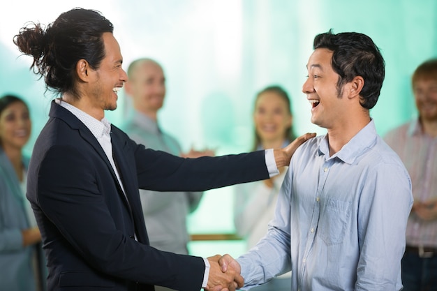 Smiling Asian Business Man Greeting Male Partner