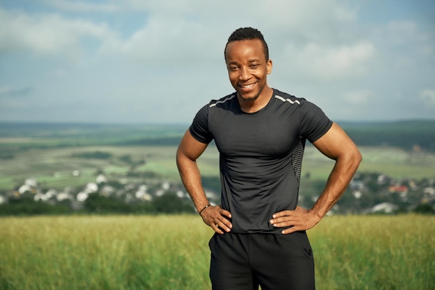 Smiling athlete holding hands on hips posing