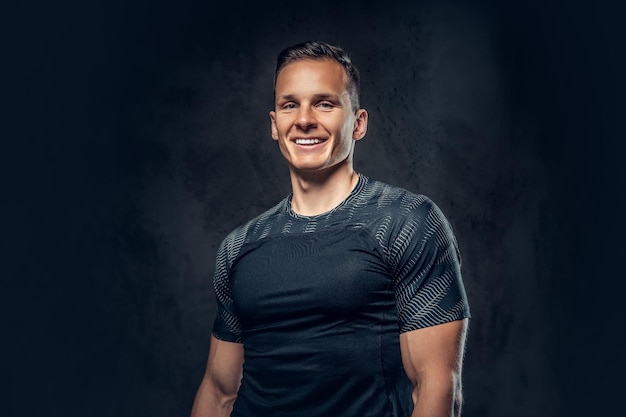 Free photo smiling athletic man on black background.