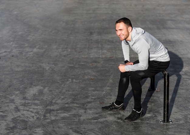 Smiling athletic man looking away