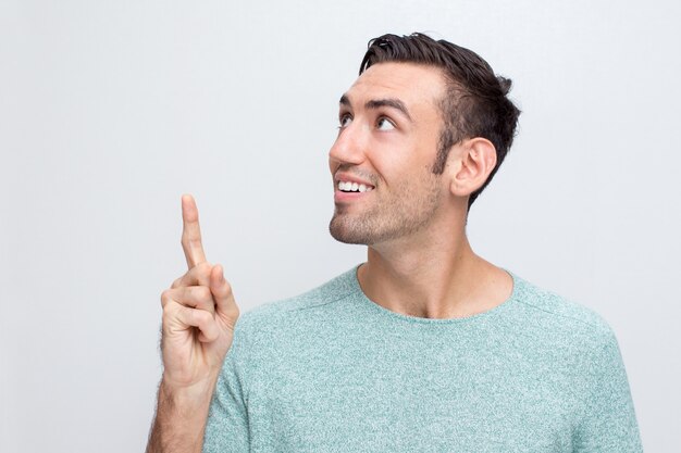 Smiling Attractive Man Pointing Upwards