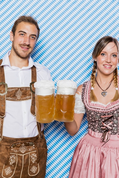 Foto gratuita coppie bavaresi sorridenti con le tazze di birra