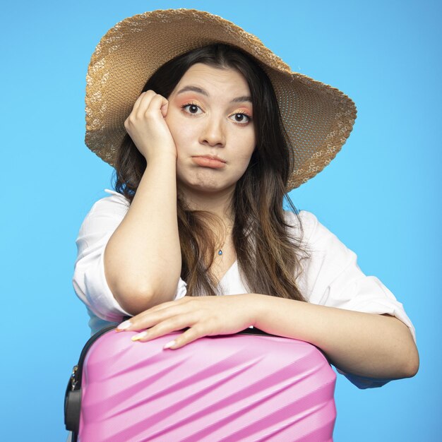 Smiling beautiful girl in hat goes on holiday wants to rest