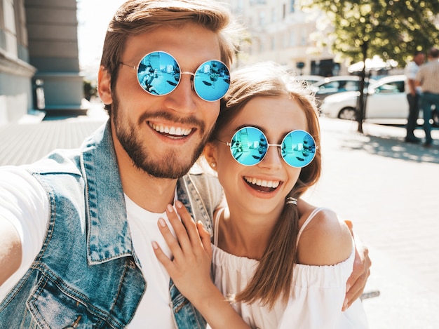 Smiling beautiful girl and her handsome boyfriend in casual summer clothes