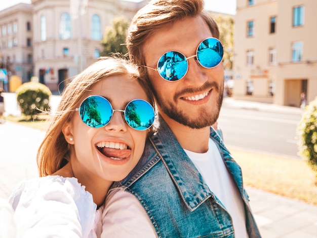 Free photo smiling beautiful girl and her handsome boyfriend in casual summer clothes.