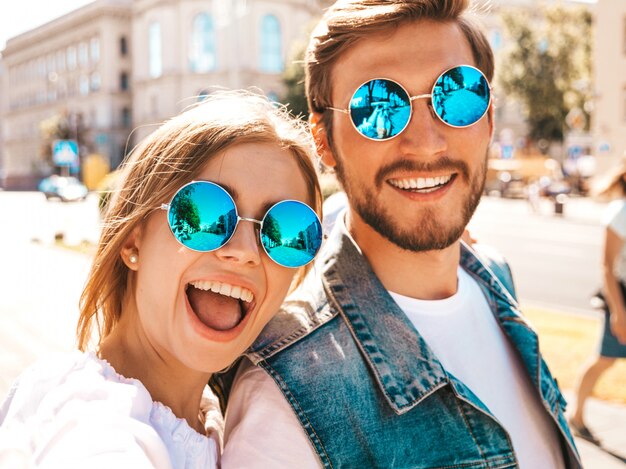 Smiling beautiful girl and her handsome boyfriend in casual summer clothes.