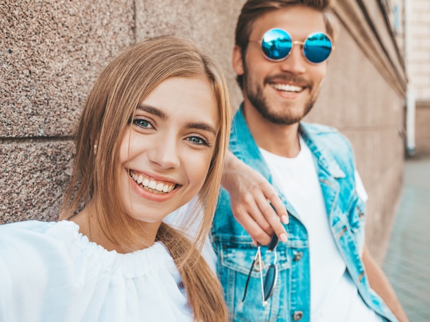 Smiling beautiful girl and her handsome boyfriend in casual summer clothes