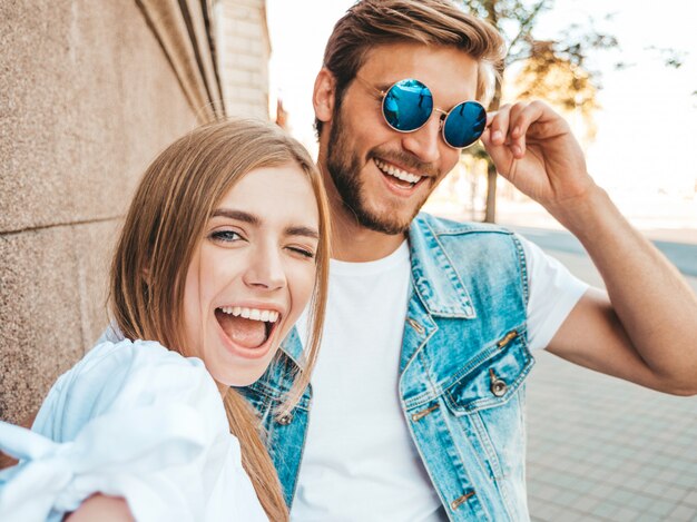 Smiling beautiful girl and her handsome boyfriend in casual summer clothes